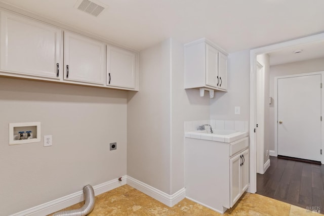clothes washing area featuring a sink, hookup for an electric dryer, baseboards, visible vents, and hookup for a washing machine