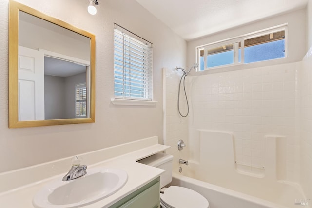 bathroom with shower / bath combination, toilet, and vanity