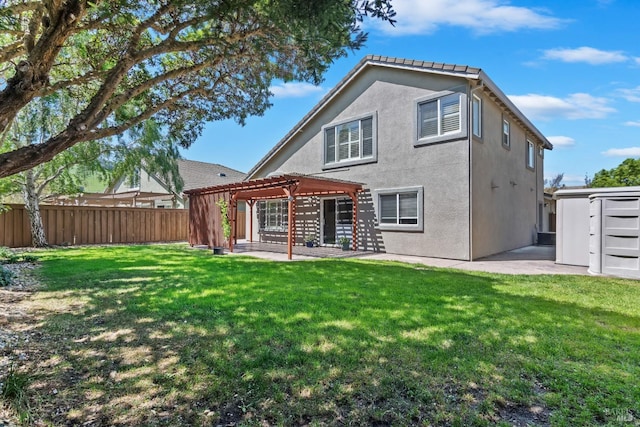 back of house featuring stucco siding, a pergola, a fenced backyard, and a patio