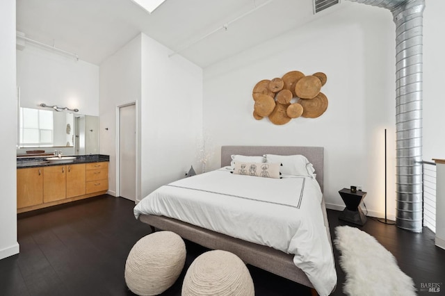 bedroom with high vaulted ceiling, baseboards, dark wood-type flooring, and a sink