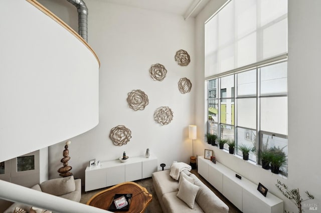 living room featuring a towering ceiling