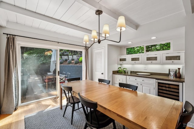 90 Corte Placida, Greenbrae, CA 94904 - dining room featuring bar with sink, beamed ceiling, wood finished floors, wine cooler, and a chandelier