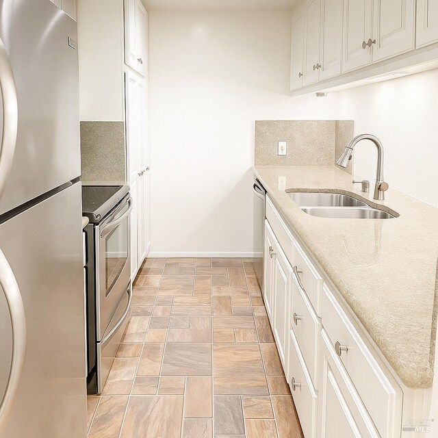 935 Hunt Ave, Saint Helena, CA 94574 - kitchen with appliances with stainless steel finishes, a sink, baseboards, white cabinets, and light stone countertops