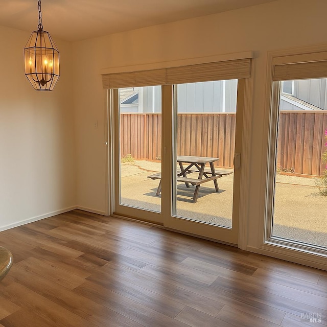 935 Hunt Ave, Saint Helena, CA 94574 - spare room with a chandelier, wood finished floors, and baseboards