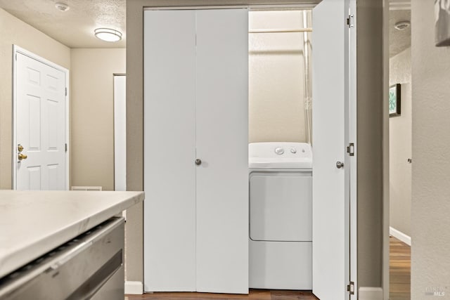 laundry room with washer / dryer, wood finished floors, and laundry area