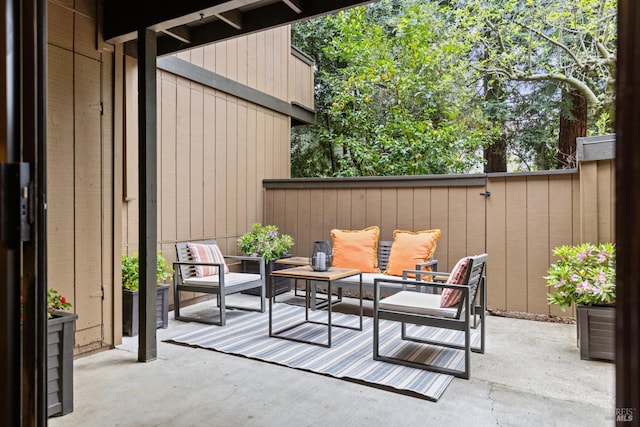 view of patio / terrace with an outdoor living space and fence