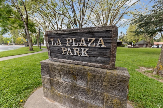 community / neighborhood sign with a lawn
