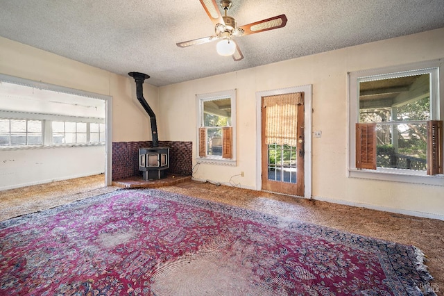 735 Robinson Rd, Sebastopol, CA 95472 - unfurnished living room featuring a ceiling fan, carpet flooring, a textured ceiling, and a wood stove