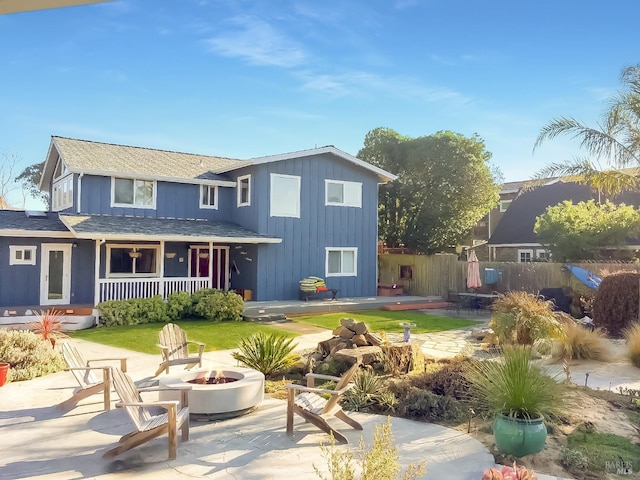1 Joaquin Patio, Stinson Beach, CA 94970 - rear view of house featuring fence, a porch, board and batten siding, and a fire pit
