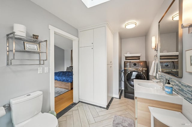 1 Joaquin Patio, Stinson Beach, CA 94970 - bathroom featuring a skylight, vanity, toilet, and washer / clothes dryer