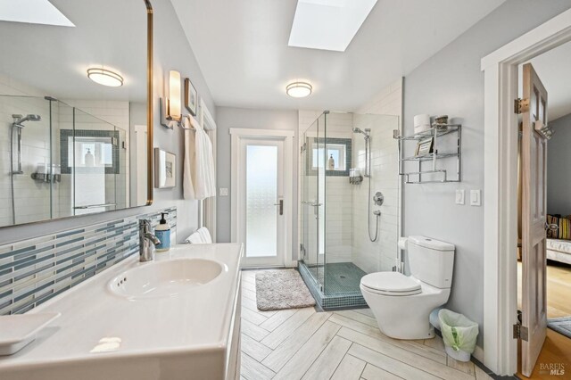 1 Joaquin Patio, Stinson Beach, CA 94970 - bathroom featuring vanity, toilet, a stall shower, backsplash, and a skylight