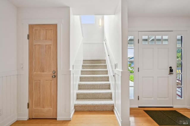 1 Joaquin Patio, Stinson Beach, CA 94970 - entrance foyer with wainscoting, wood finished floors, stairway, and a decorative wall