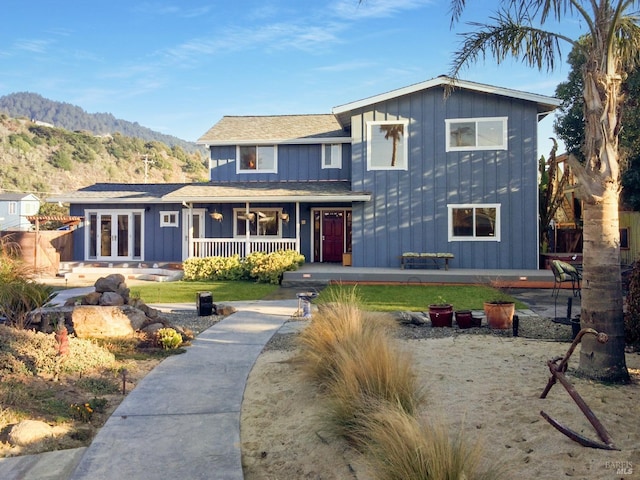 1 Joaquin Patio, Stinson Beach, CA 94970 - traditional home featuring board and batten siding, covered porch, french doors, and a mountain view