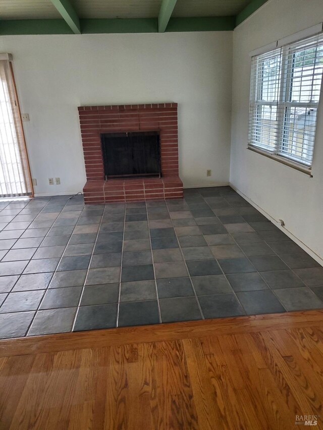 639 E 5th St, Benicia, CA 94510 - unfurnished living room with beam ceiling, a fireplace, and tile patterned flooring