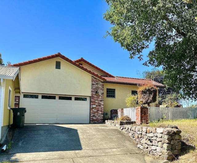 639 E 5th St, Benicia, CA 94510 - view of side of property with stucco siding, a garage, concrete driveway, fence, and a tiled roof