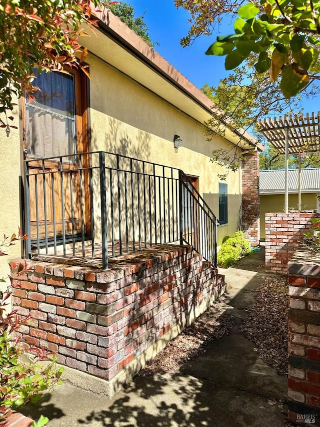 639 E 5th St, Benicia, CA 94510 - view of side of property featuring stucco siding and a pergola