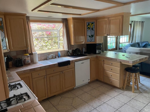 639 E 5th St, Benicia, CA 94510 - kitchen with white dishwasher, a peninsula, tile countertops, and a sink