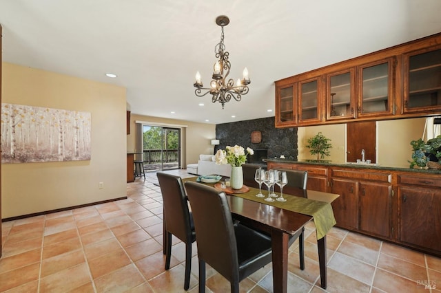dining space with baseboards, recessed lighting, light tile patterned floors, and a notable chandelier