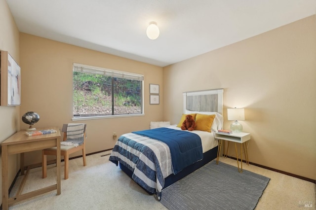 bedroom featuring carpet and baseboards