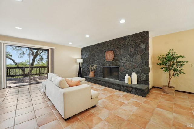 living room featuring light tile patterned floors, recessed lighting, and a stone fireplace