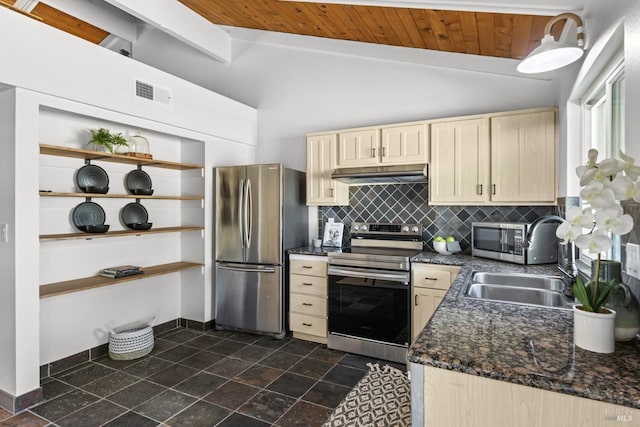 kitchen featuring vaulted ceiling with beams, decorative backsplash, light brown cabinetry, stainless steel appliances, and under cabinet range hood