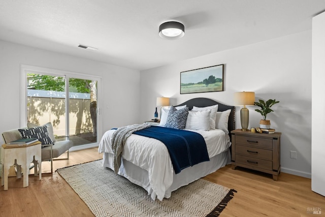 bedroom with baseboards, visible vents, access to exterior, and light wood finished floors