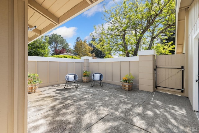 view of patio / terrace with fence and a gate