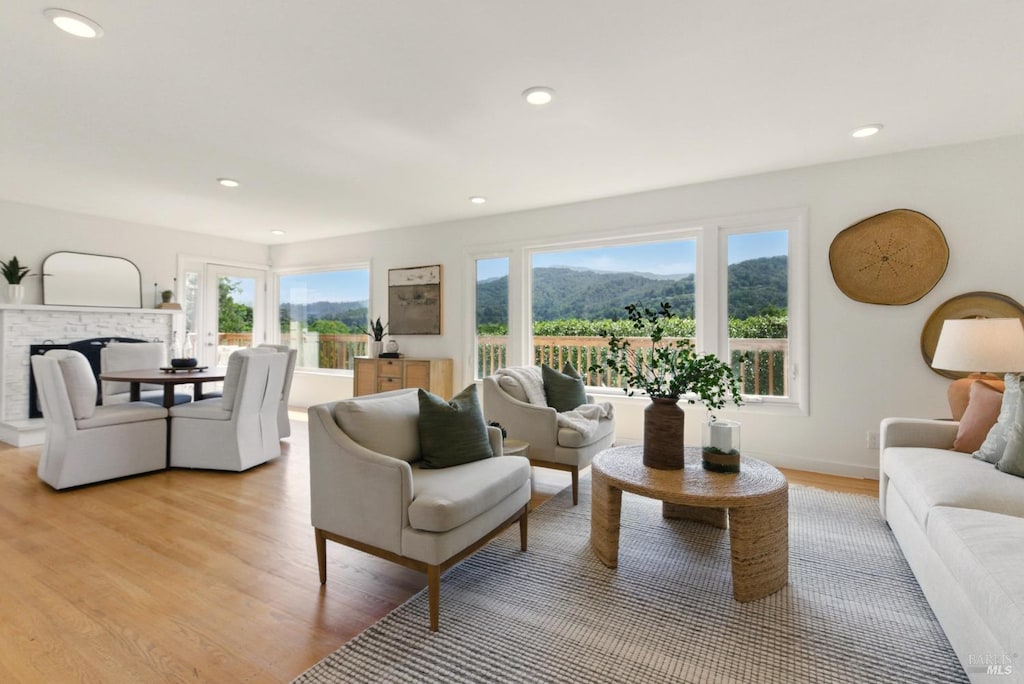 42 Ridge Rd, San Anselmo, CA 94960 - living room with a healthy amount of sunlight, a fireplace, and light wood finished floors