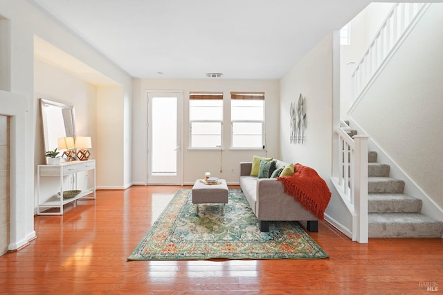 1606 Chamberlain Dr, Fairfield, CA 94533 - living room featuring visible vents, stairway, and wood finished floors