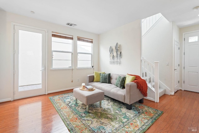 1606 Chamberlain Dr, Fairfield, CA 94533 - living room featuring visible vents, a healthy amount of sunlight, light wood finished floors, and stairs