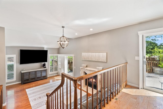 stairway with recessed lighting, baseboards, wood finished floors, and plenty of natural light