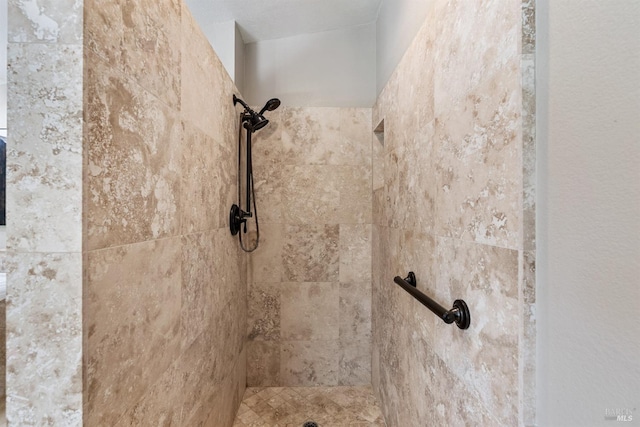 interior details featuring a tile shower