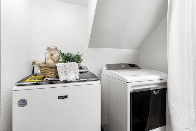 laundry area with washer and clothes dryer and laundry area