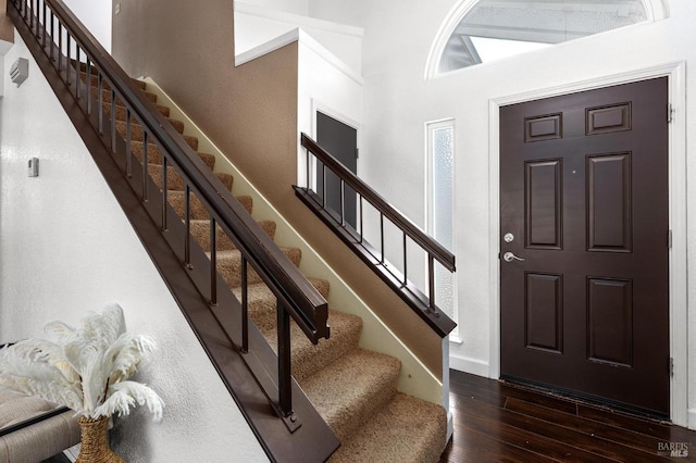 foyer with stairway and hardwood / wood-style flooring