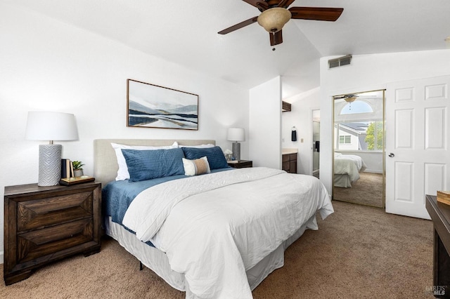 bedroom featuring vaulted ceiling, light carpet, ceiling fan, ensuite bathroom, and visible vents