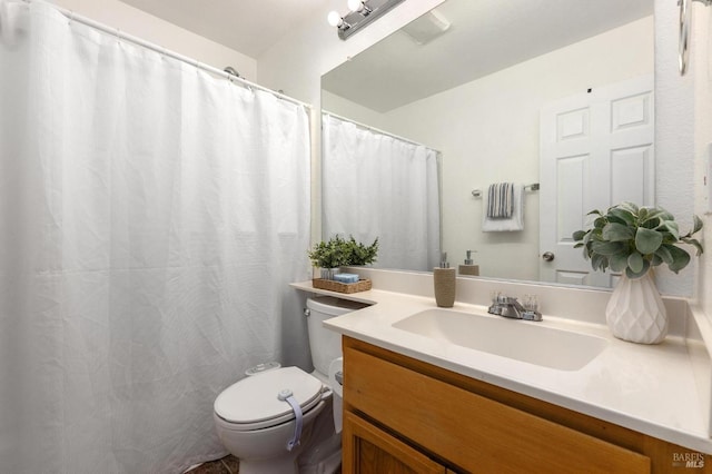 bathroom featuring vanity and toilet