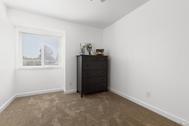bedroom with carpet floors and baseboards