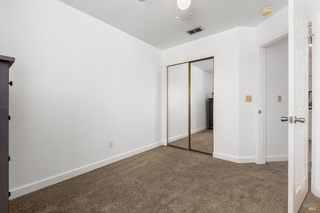 unfurnished bedroom featuring carpet flooring, a closet, visible vents, and baseboards