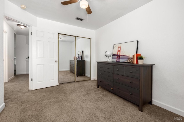 carpeted bedroom featuring a closet, visible vents, ceiling fan, and baseboards