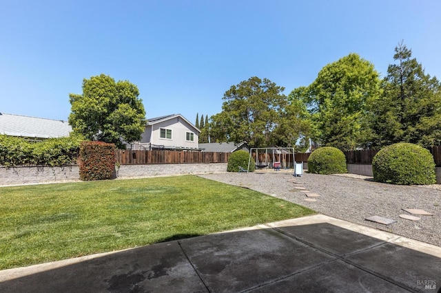 view of yard with a fenced backyard, a playground, and a patio area