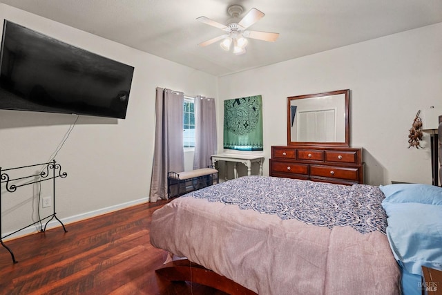 bedroom with baseboards, wood finished floors, and a ceiling fan