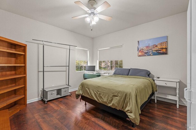 bedroom with wood finished floors, a ceiling fan, and baseboards