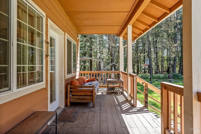 wooden deck with an outdoor living space