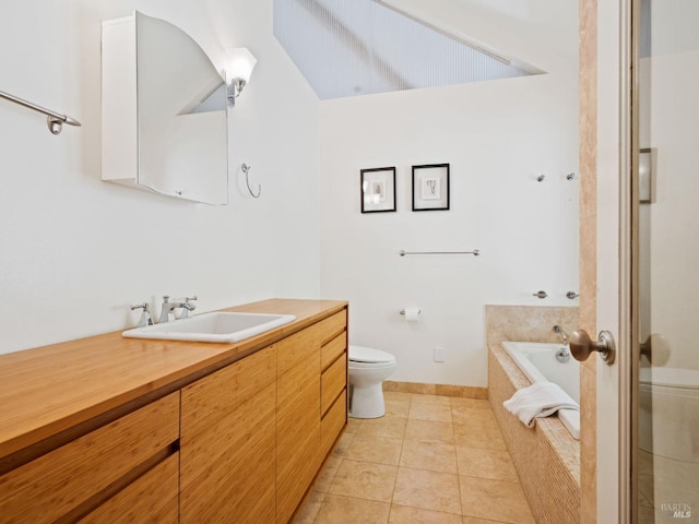 bathroom with toilet, tile patterned flooring, a bath, and vanity