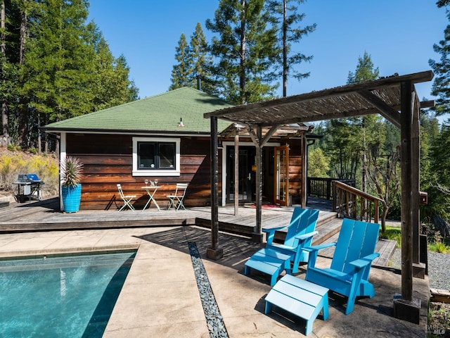 rear view of house with an outdoor pool, a pergola, and a wooden deck