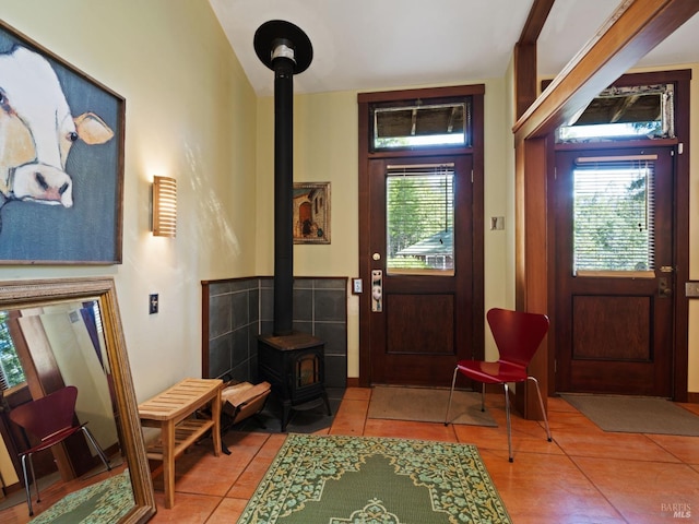 tiled entrance foyer with a wood stove