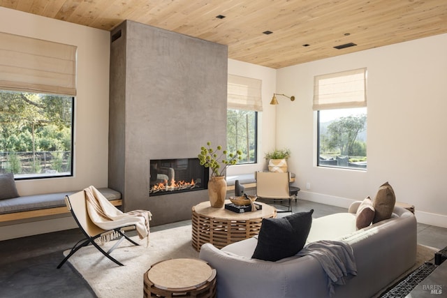 living area featuring a large fireplace, baseboards, visible vents, and wooden ceiling