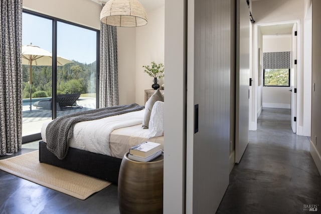bedroom with baseboards, access to outside, and multiple windows