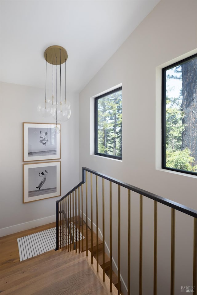 stairs with baseboards and wood finished floors