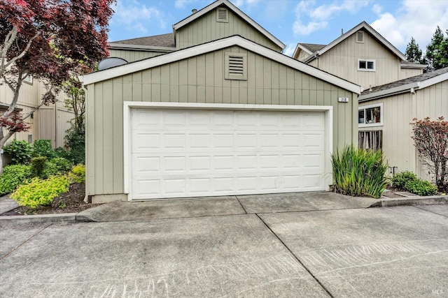 garage featuring concrete driveway